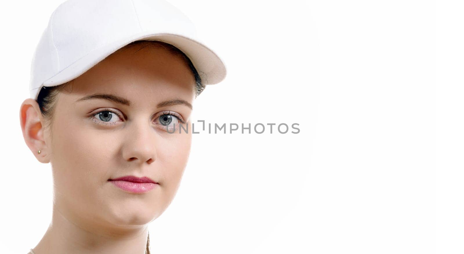 a close up of the face of a pretty young woman with a white cap
