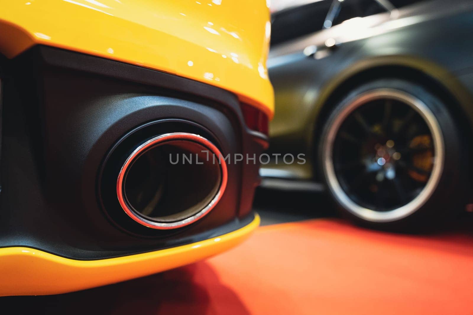 detail rear view of black sport car exhaust pipe