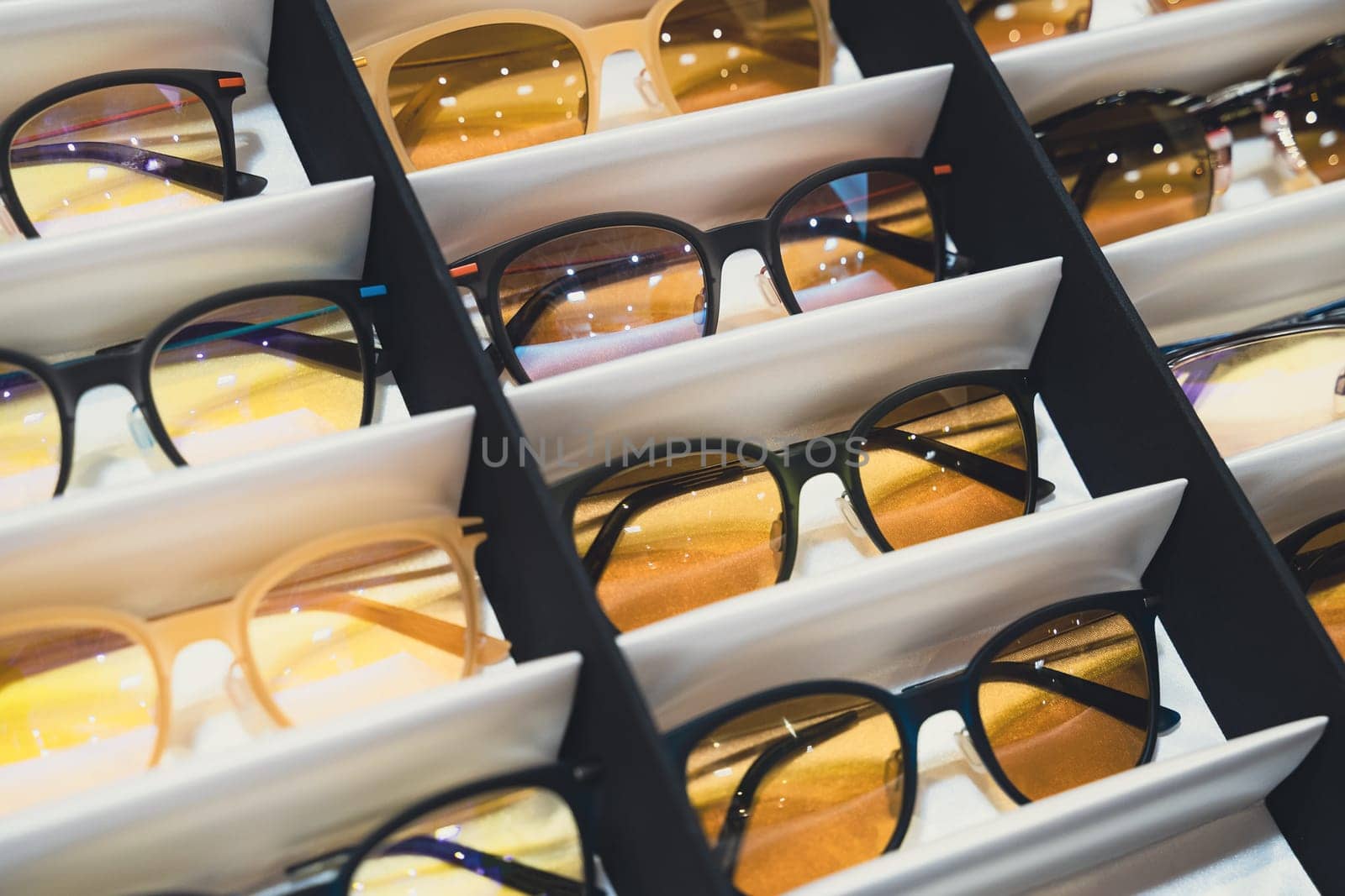 perspective view closeup of medical sunglasses in packaging boxes in store display shelf