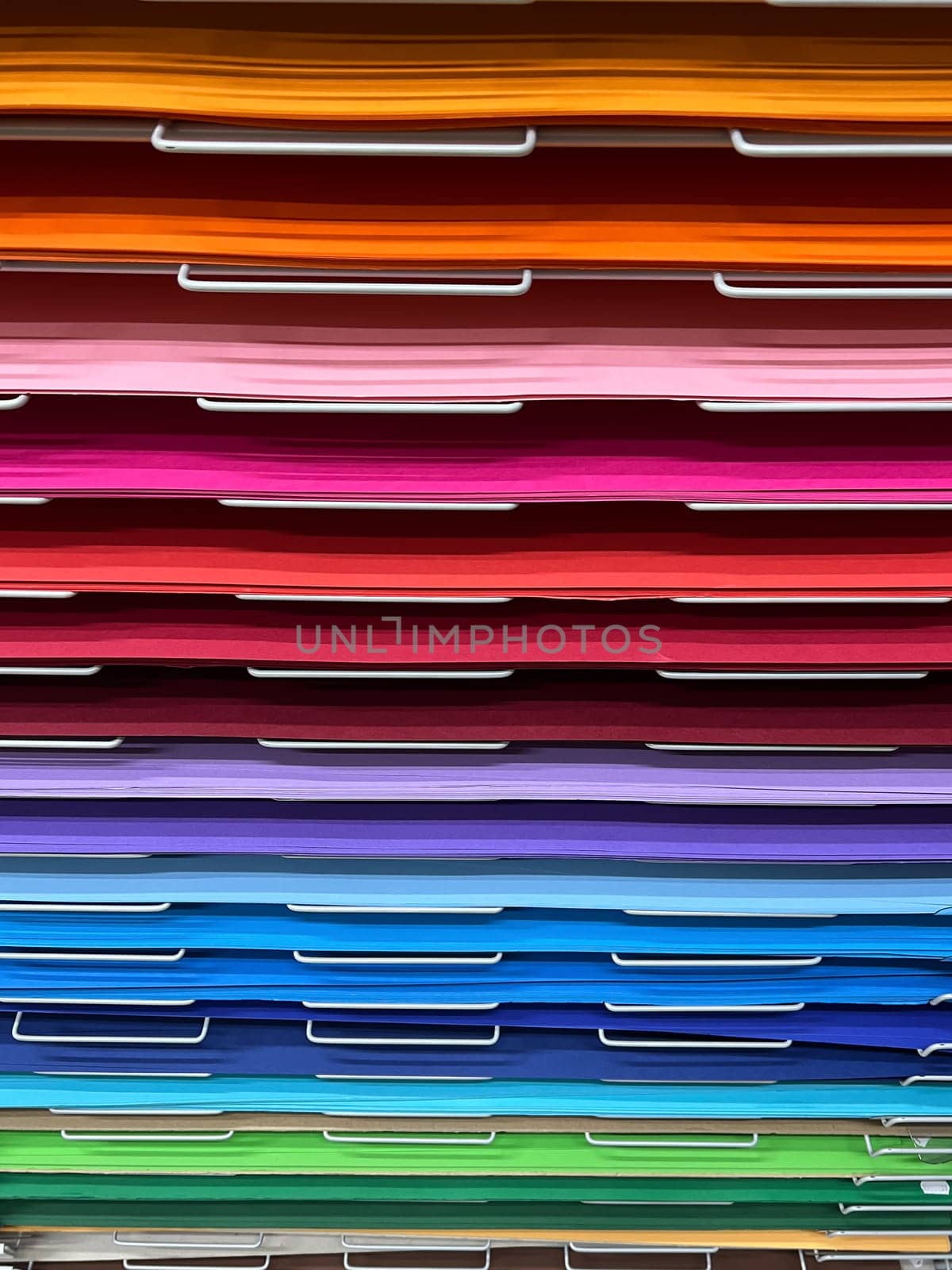 closeup front view of many various art colored paper cardboard canvas samples on display shelf