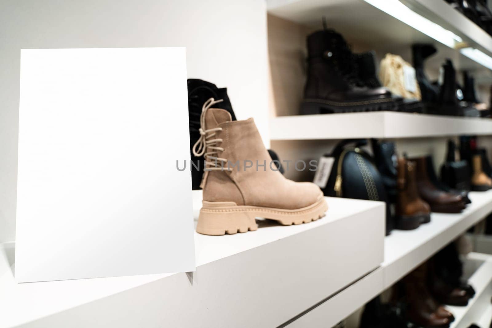 perspective view of point of sale empty shelf sign poster holder mockup in retail shoe store window