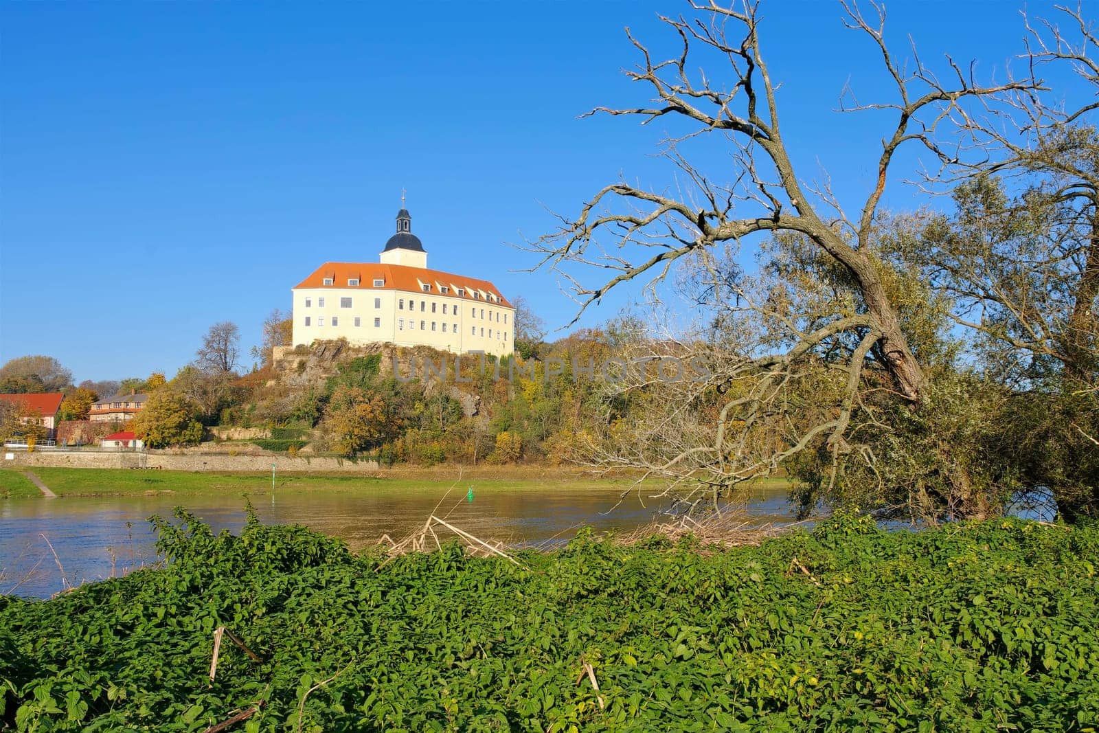 the palace Hirschstein on river Elbe in autumn