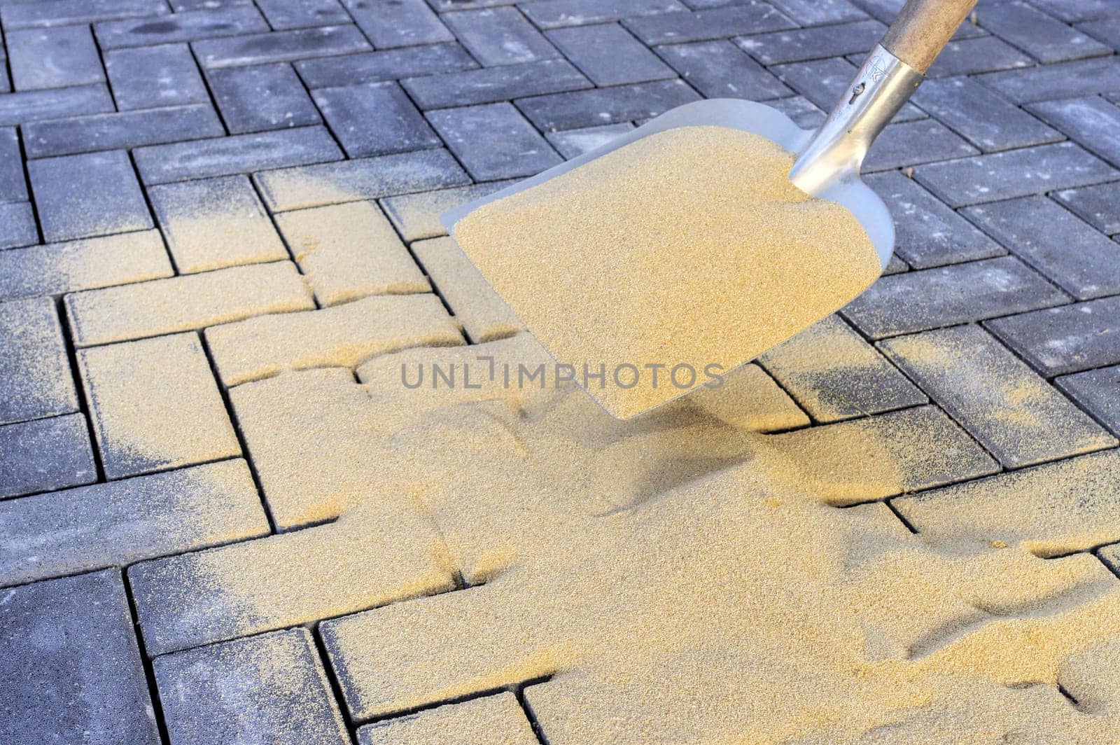 Sweeping in joint sand on a construction site
