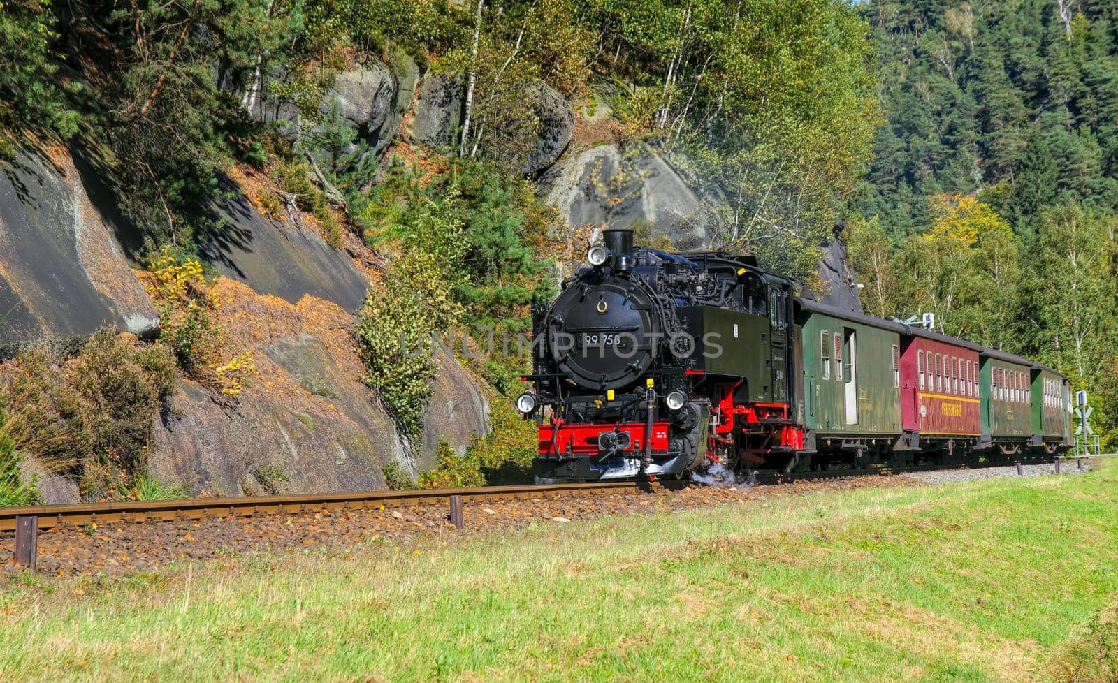 old steam locomotive in rocky mountains landscape