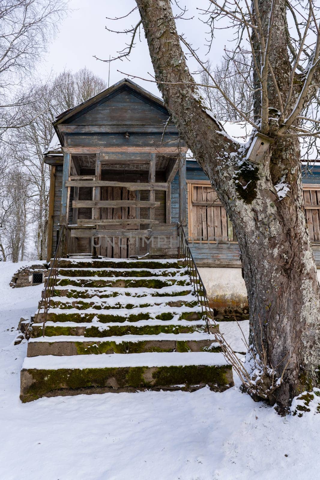 Old barn in the village on a winter day