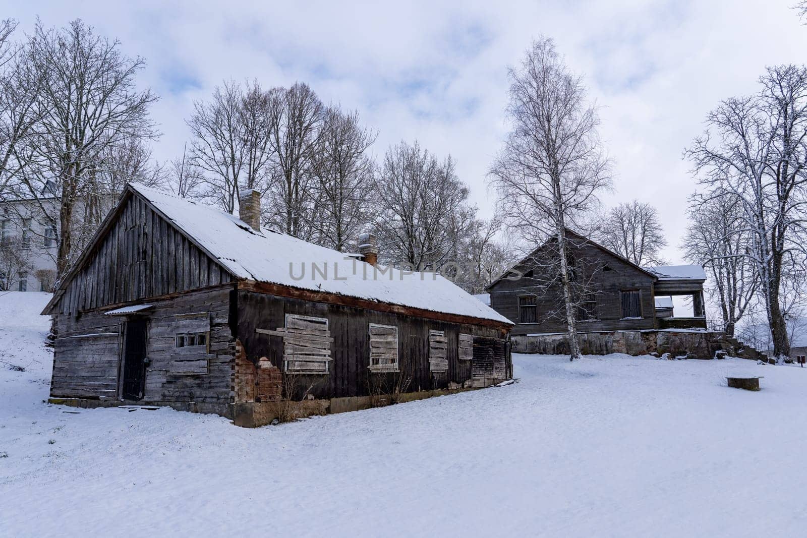 Old barn in the village on a winter day