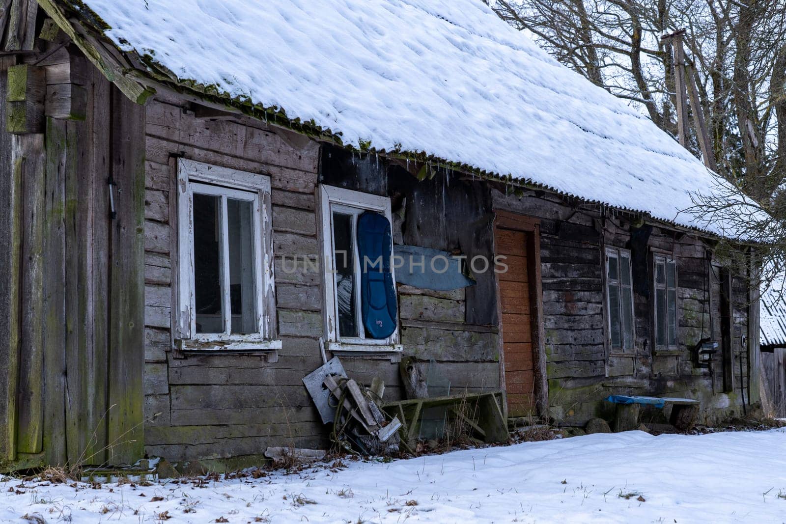 Old wooden abandoned and ruinous country house in rural