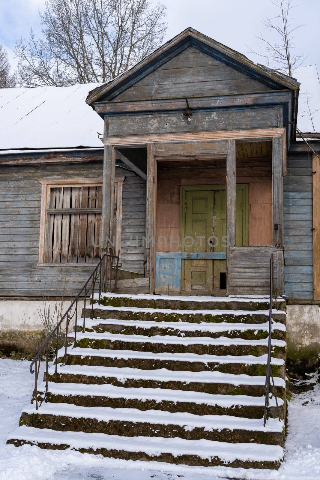 Old barn in the village on a winter day
