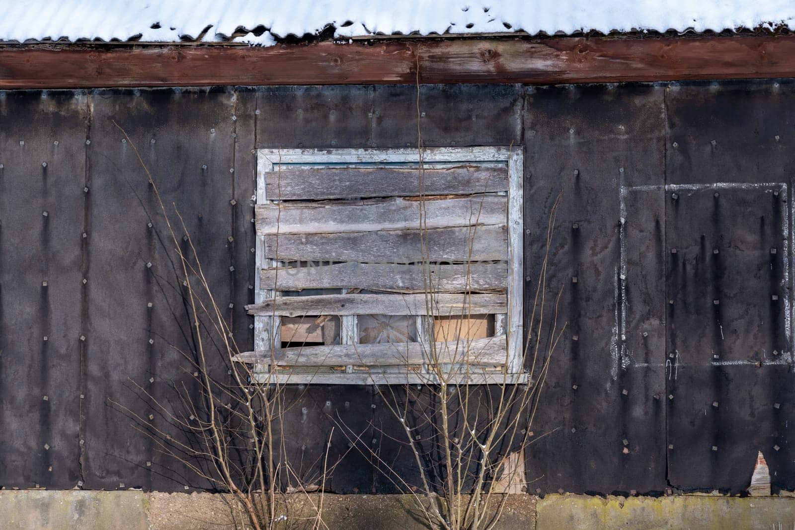 Old barn in the village on a winter day