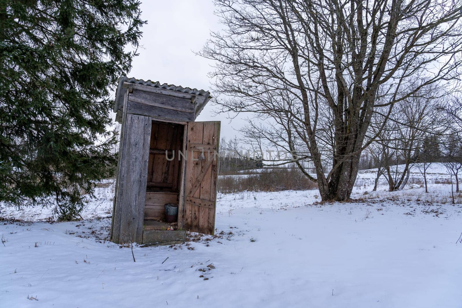 Old abandoned wooden outdoor toilet in the countryside