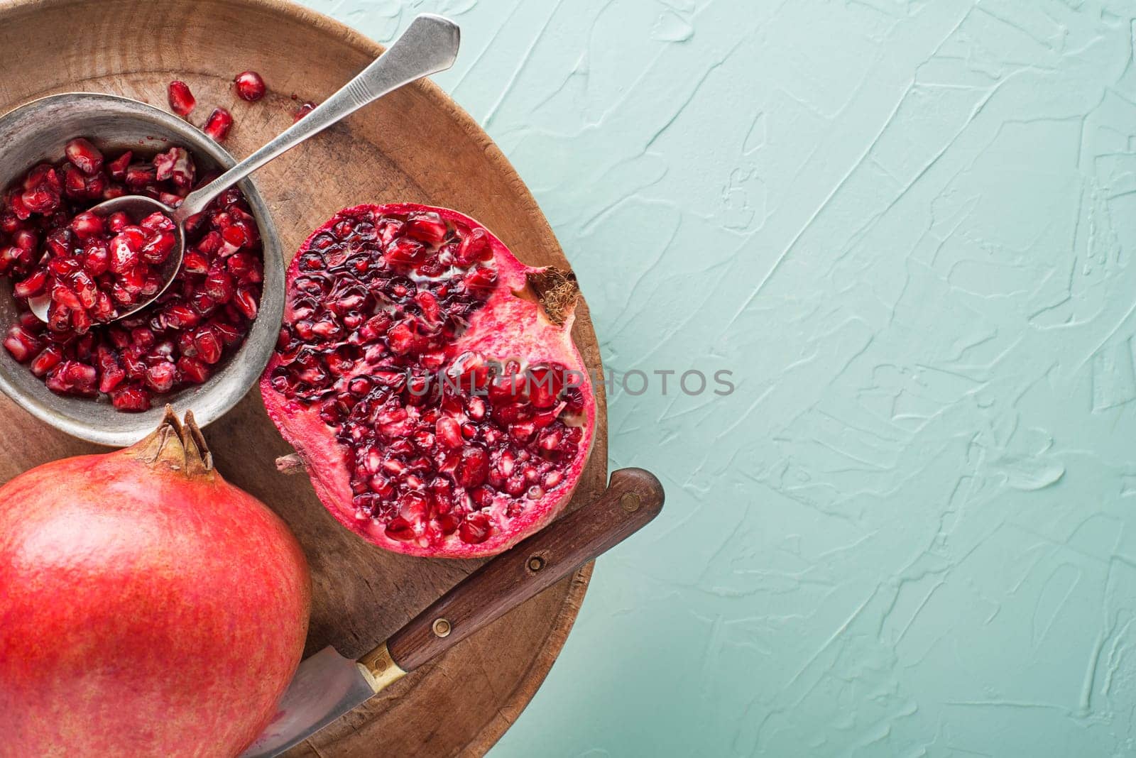 Cutting Fresh pomegranate for healthy seeds close up