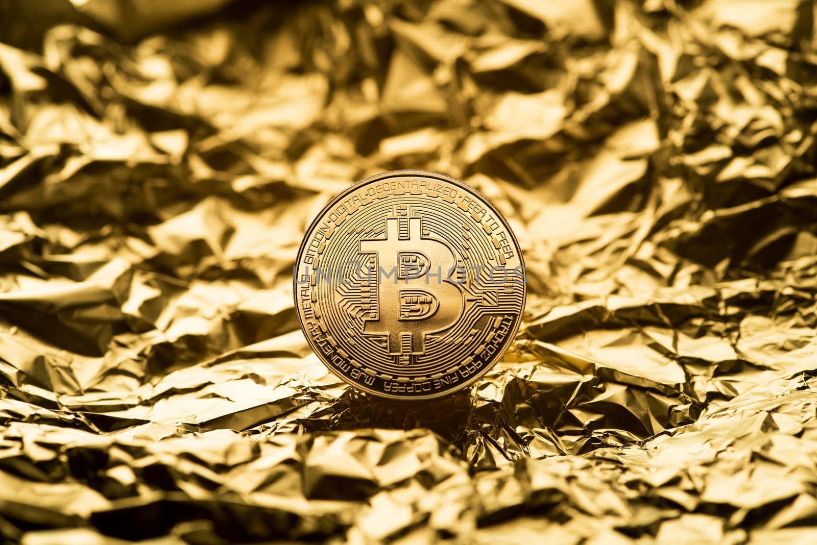 Golden coin with bitcoin symbol close up. Bitcoin and cryptocurrency investing concept. Bitcoin cryptocurrency coin. Trading on the cryptocurrency exchange. Trends in bitcoin exchange rates.