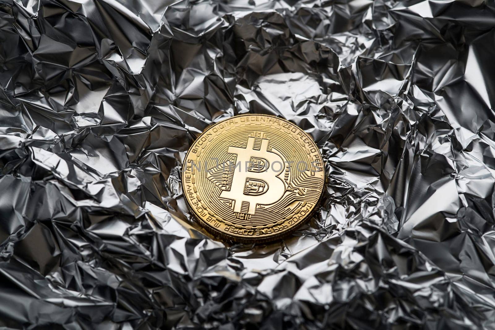 Golden coin with bitcoin symbol close up. Bitcoin and cryptocurrency investing concept. Bitcoin cryptocurrency coin. Trading on the cryptocurrency exchange. Trends in bitcoin exchange rates.