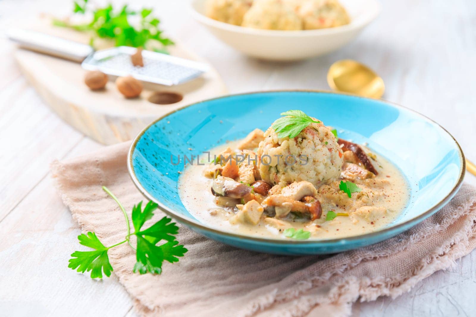 Homemade Bavarian bread dumpling, called in south Germany as Semmelknoedel with creamed mushroom sauce