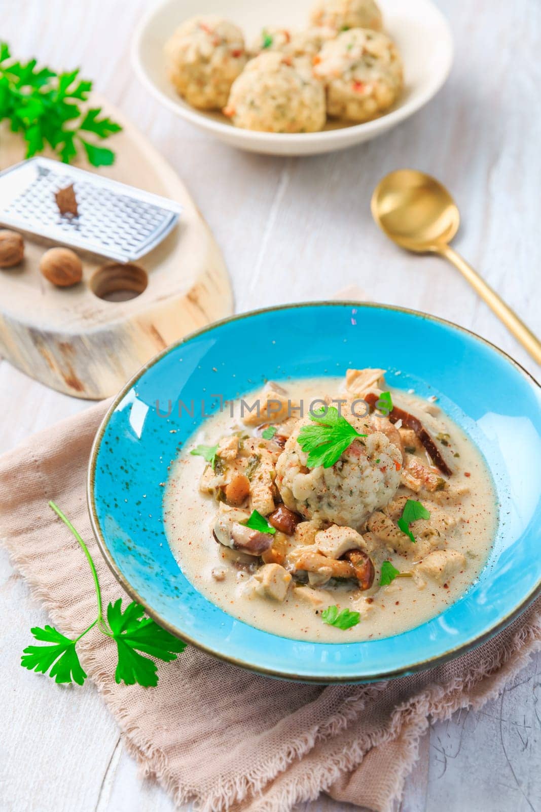 Homemade Bavarian bread dumpling, called in south Germany as Semmelknoedel with creamed mushroom sauce