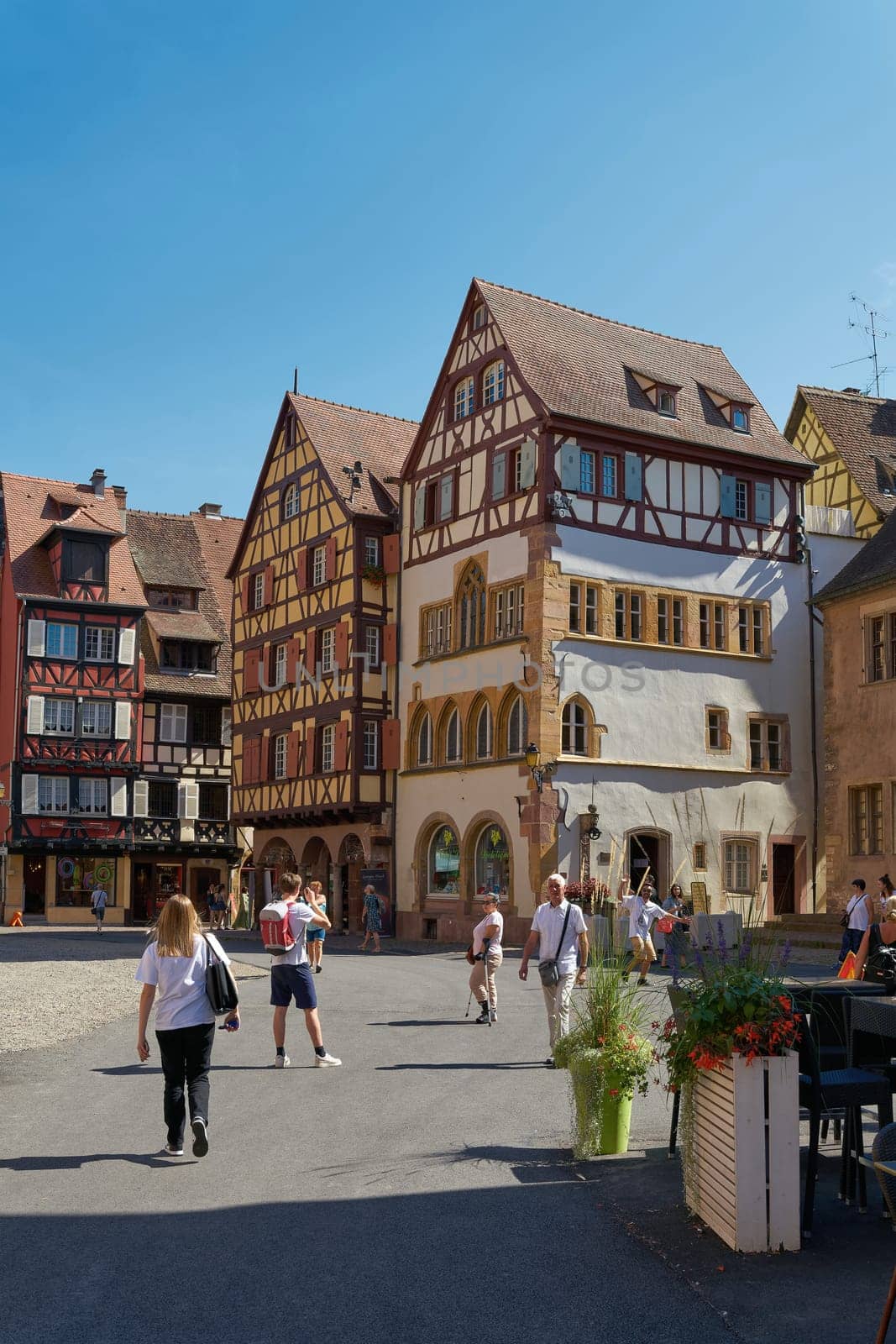 Tourists from all over the world in the picturesque medieval old town of Colmar in France