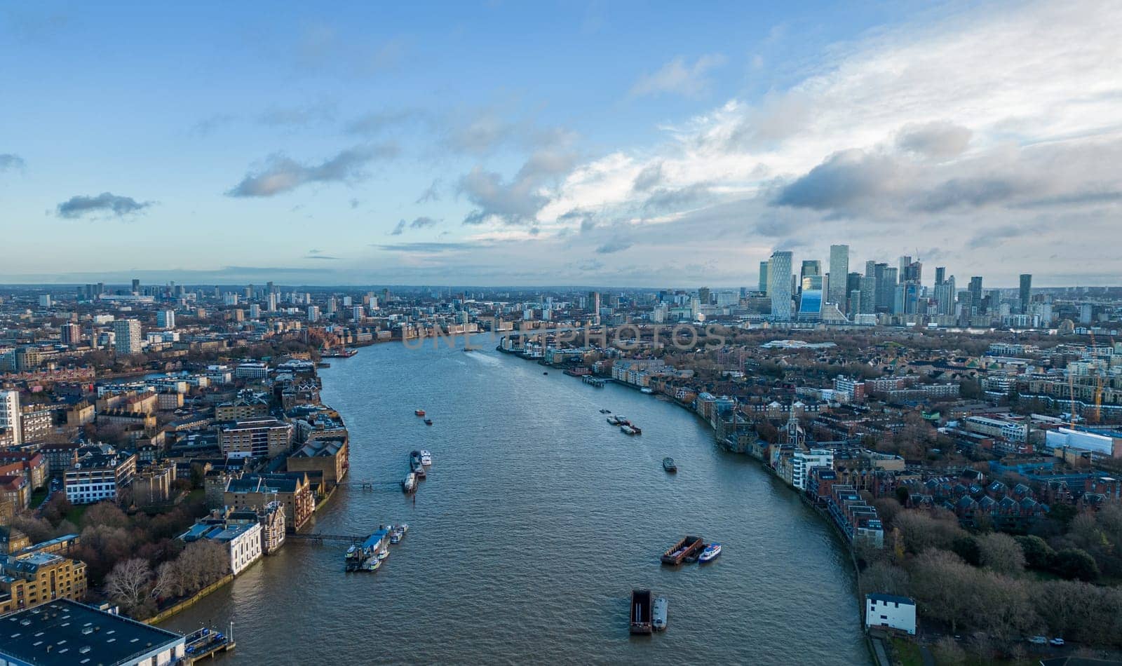 Aerial view over River Thames and Canary Wharf in London - LONDON, UNITED KINGDOM - DECEMBER 20, 2022