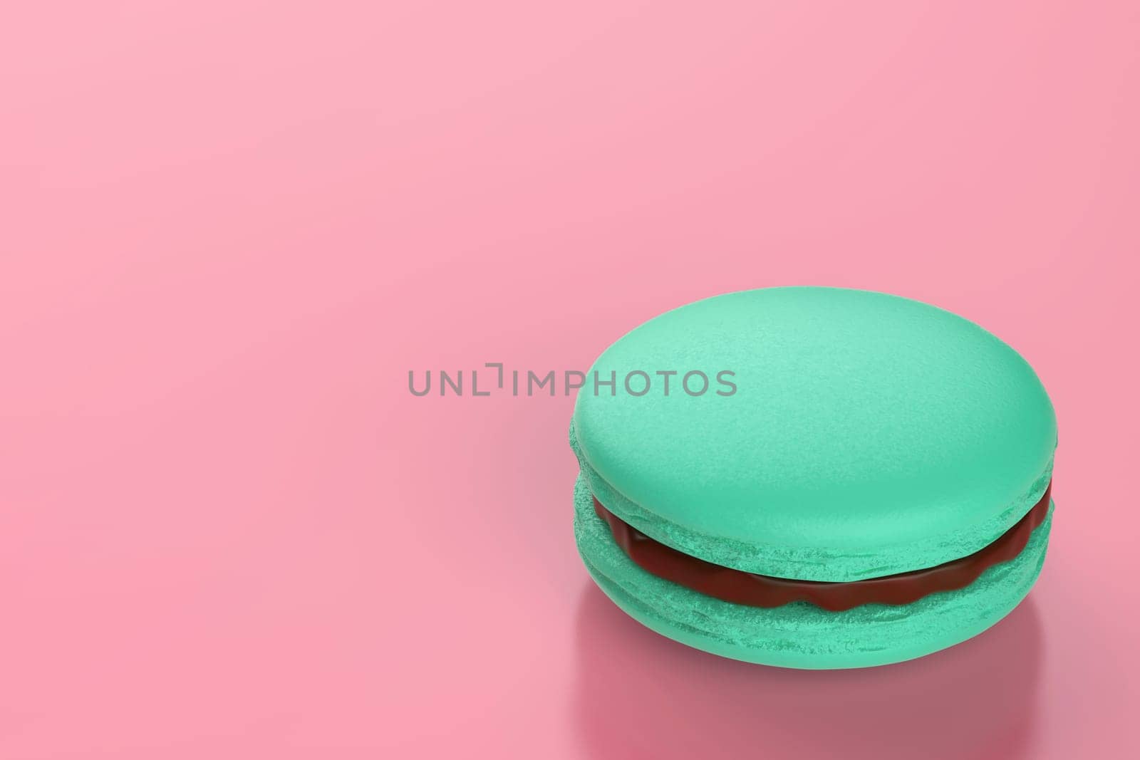 Green french macaron filled with chocolate cream on pink background