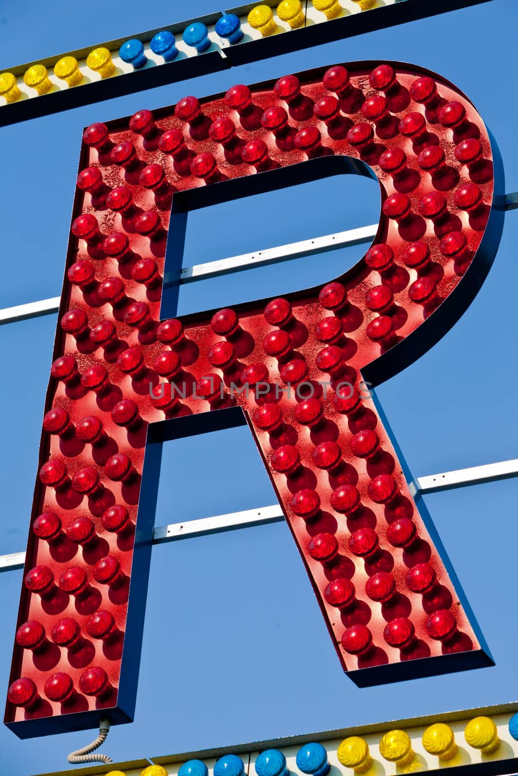 classic electric sign like the ones used in circus or old fashioned shops representing the R letter