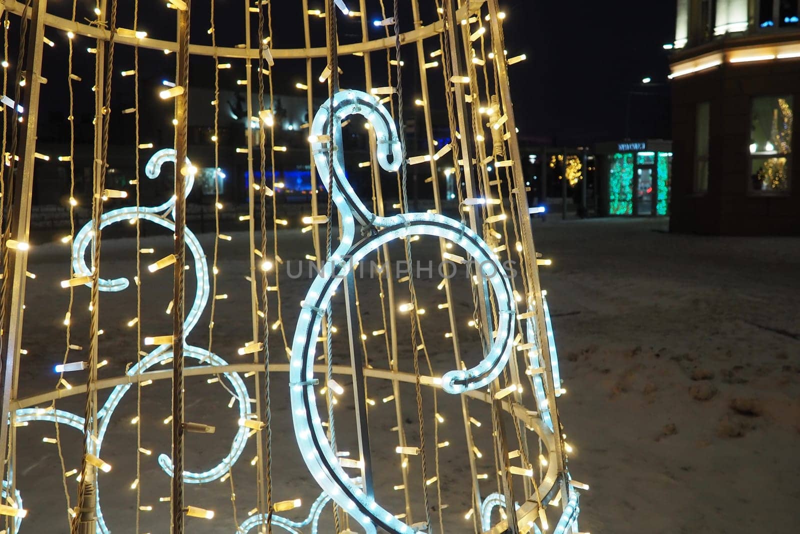 Petrozavodsk, Karelia, Russia, January 05, 2023. New Year's holiday design from garlands in the form of a Christmas tree. Illuminated facade of the building. Kirov Square. Glowing flashing light bulbs