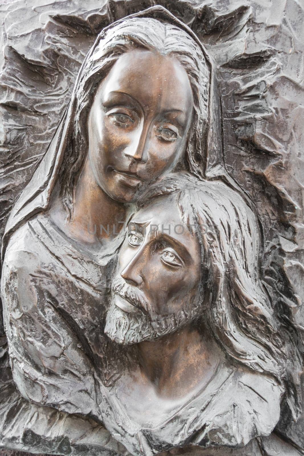Bas-relief in bronze. Faces of Holy Mary mother and Jesus Christ after the Crucifixion.