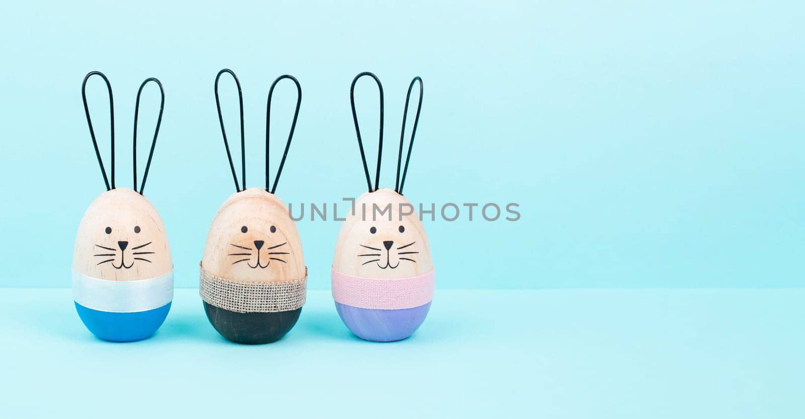 aster bunny or rabbit group, holiday background and greeting card, painted wooden egg