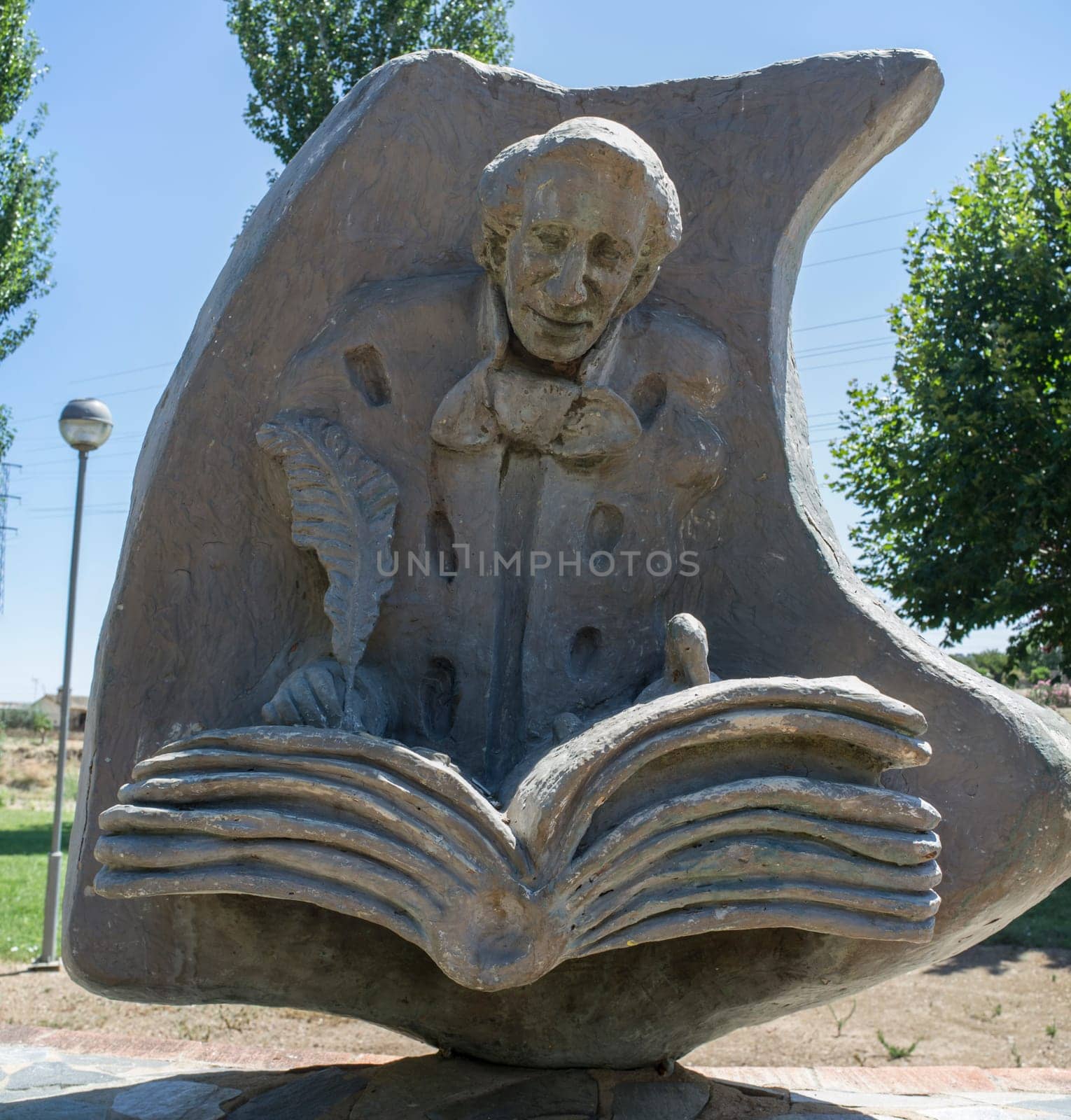 La Albuera, Spain - Jun 12th, 2021: Hans Christian Andersen monument, representing the author writing The Ugly Duckling. Badajoz, Spain.