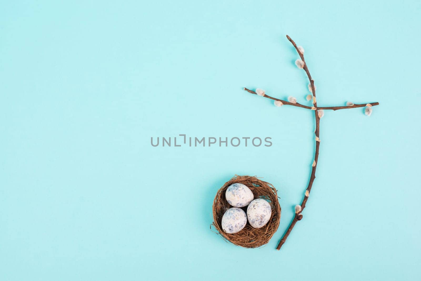 Religious cross made from willow branches, easter nest with eggs, belief, faith and spirituality in religon, resurrection of Jesus Christ, christianity