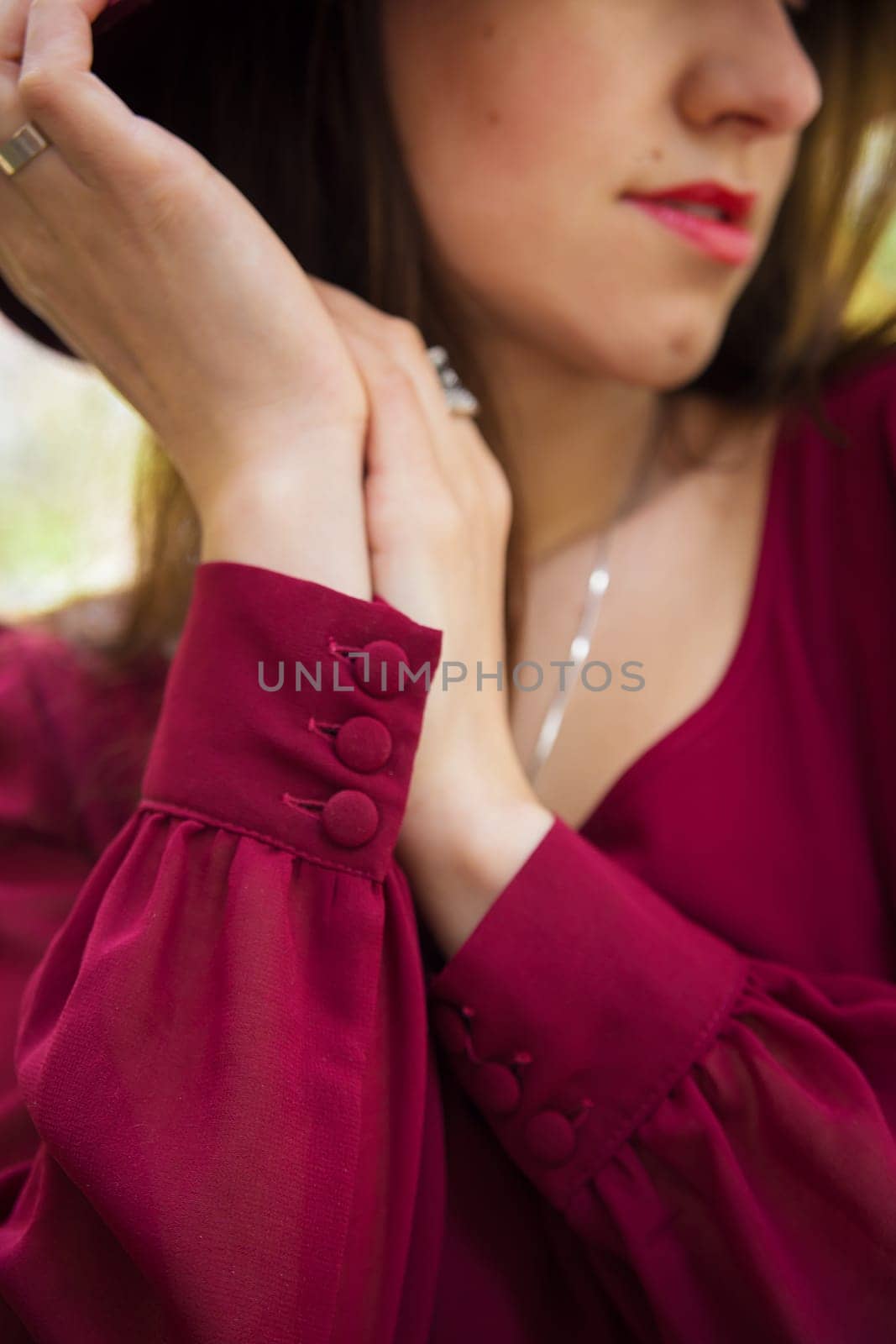beautiful girl with red lipstick, red dress, hands close-up