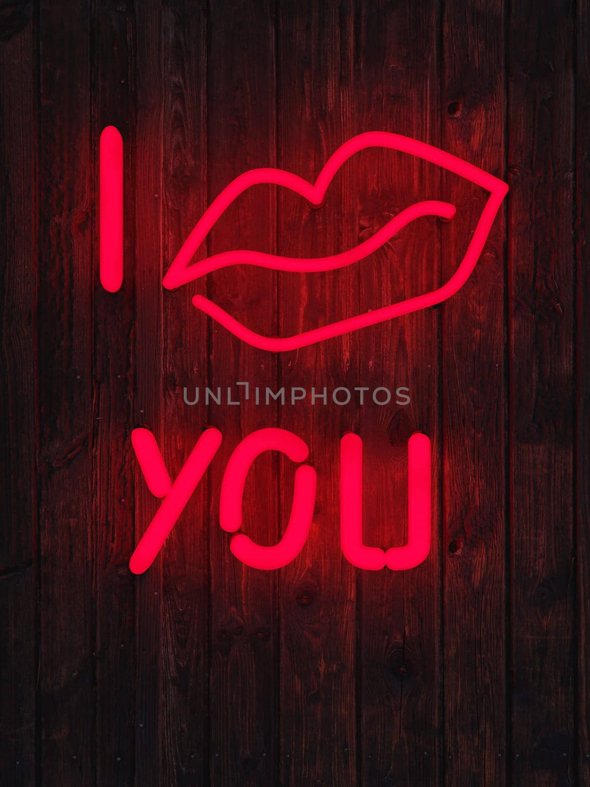 Red glowing neon light words I kiss you on a brick wall with space for your text, image or product, Happy Valentines Day concept