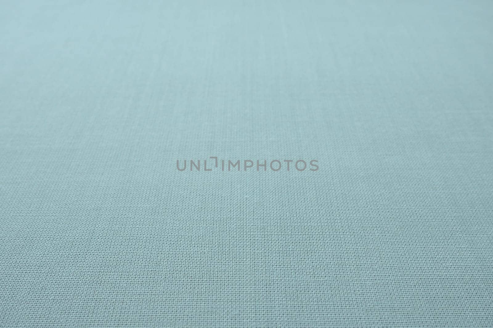 blue gray background fabric texture. A piece of woolen cloth is neatly laid out on the surface. Weave and textile texture. Dress fabric or for kitchen needs, tablecloth or curtains, close-up. Dash.