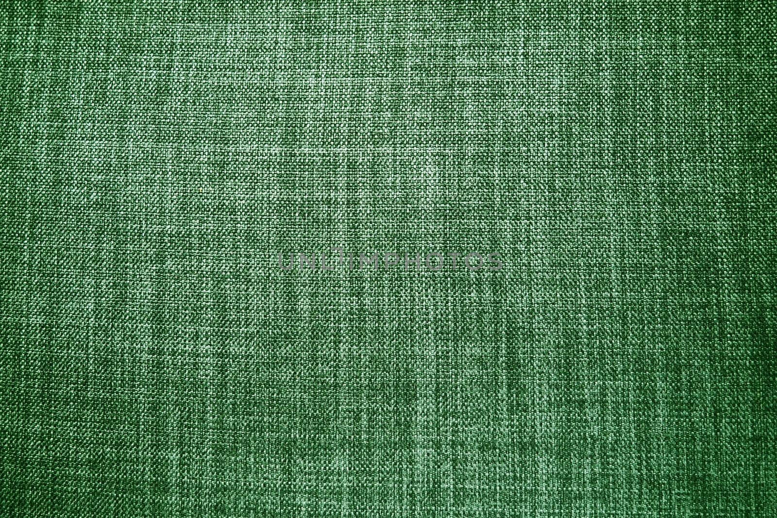 green background fabric texture. A piece of woolen cloth is neatly laid out on the surface. Weave and textile texture. Dress fabric or for kitchen needs, tablecloth or curtains, close-up. Dash.