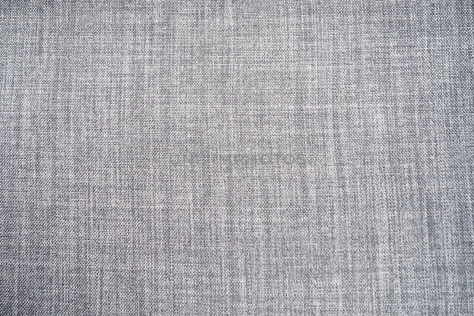 gray background fabric texture. A piece of woolen cloth is neatly laid out on the surface. Weave and textile texture. Dress fabric or for kitchen needs, tablecloth or curtains, close-up. Dash.