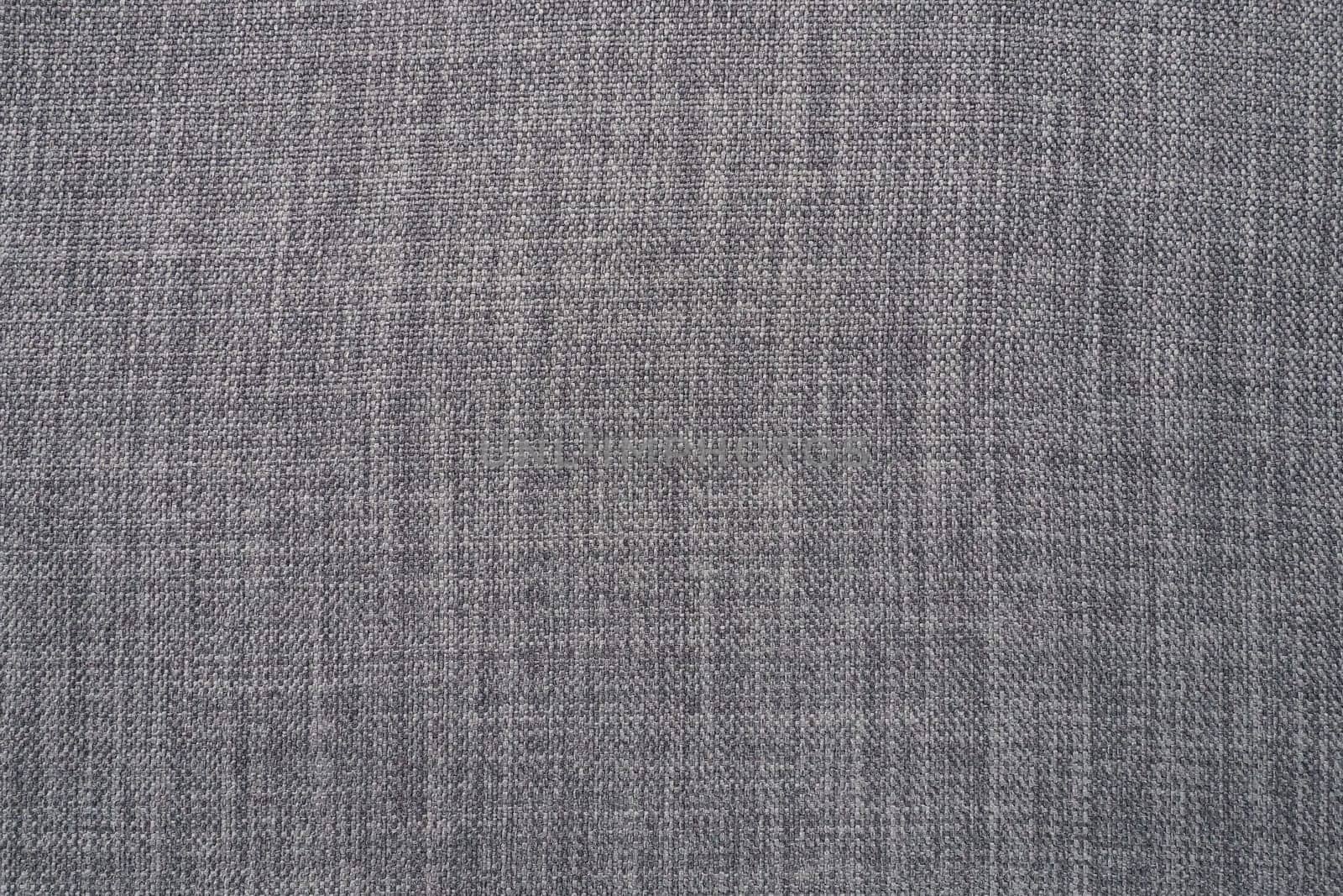 gray background fabric texture. A piece of woolen cloth is neatly laid out on the surface. Weave and textile texture. Dress fabric or for kitchen needs, tablecloth or curtains, close-up. Dash.
