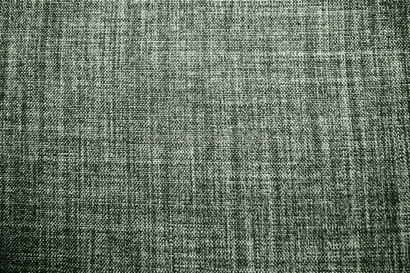 green background fabric texture. A piece of woolen cloth is neatly laid out on the surface. Weave and textile texture. Dress fabric or for kitchen needs, tablecloth or curtains, close-up. Dash.