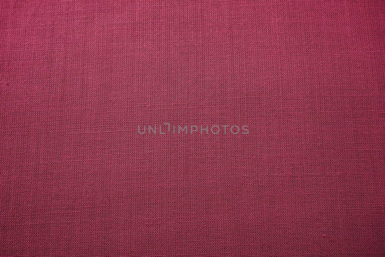 red, burgundy background fabric texture. A piece of woolen cloth is neatly laid out on the surface. Weave and textile texture. Dress fabric or for kitchen needs, tablecloth or curtains, close-up Dash.