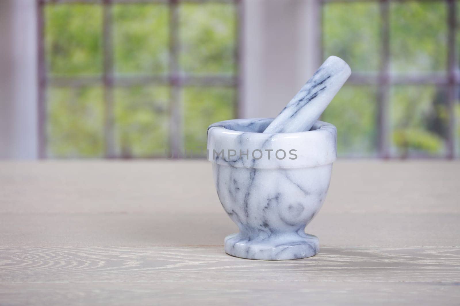 A mortar and pestle on wooden kitchen surface
