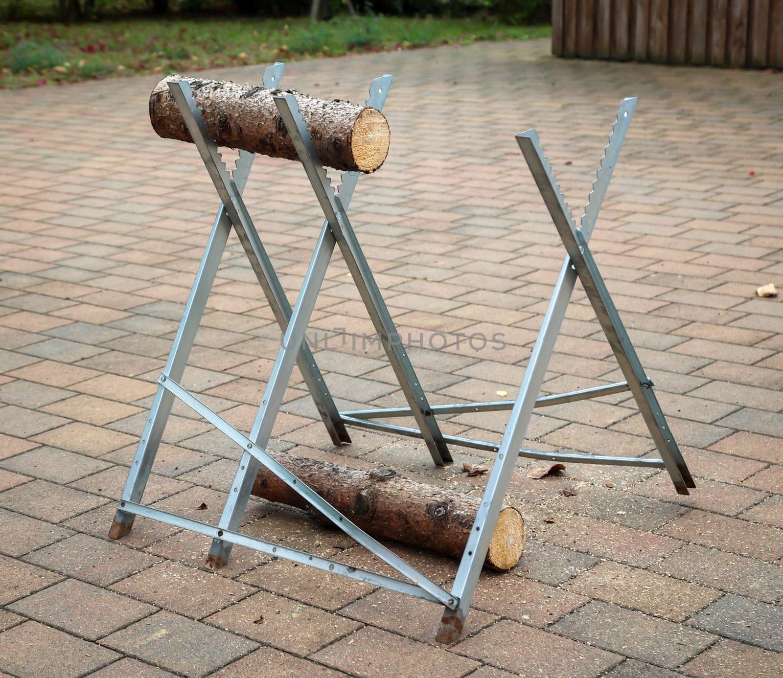 Details of a sawhorse with log and saw at a wedding.