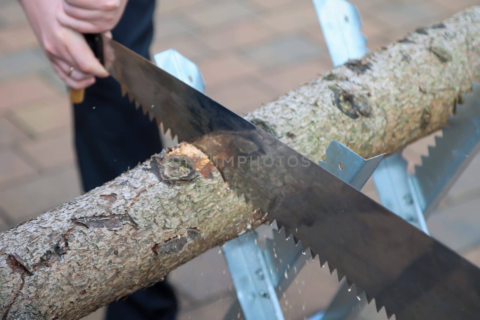 Details of a sawhorse with log and saw at a wedding.