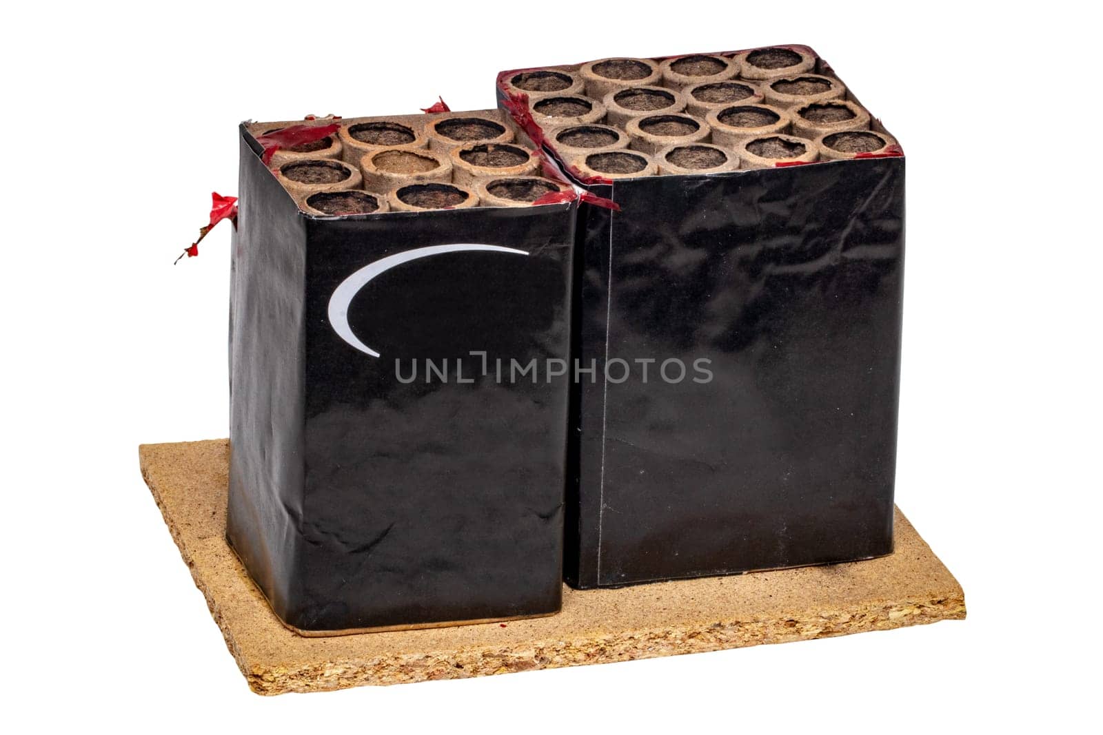 New Year's Eve waste or rubbish. Close-up of a used firework battery mounted on a wooden panel with a lot of shots. Fireworks shots. Clipping path.
