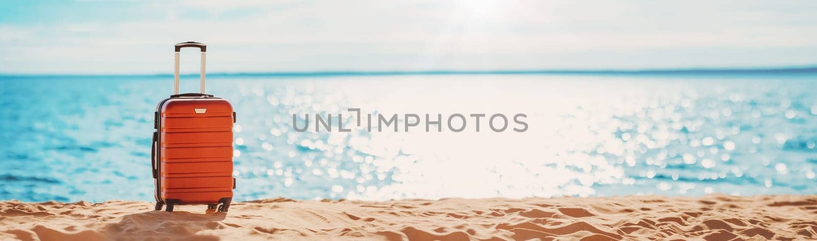 Panoramic view of the seacoast with suitcase on the sandbeach. Beautiful background. Concept of the vacation and tourism.