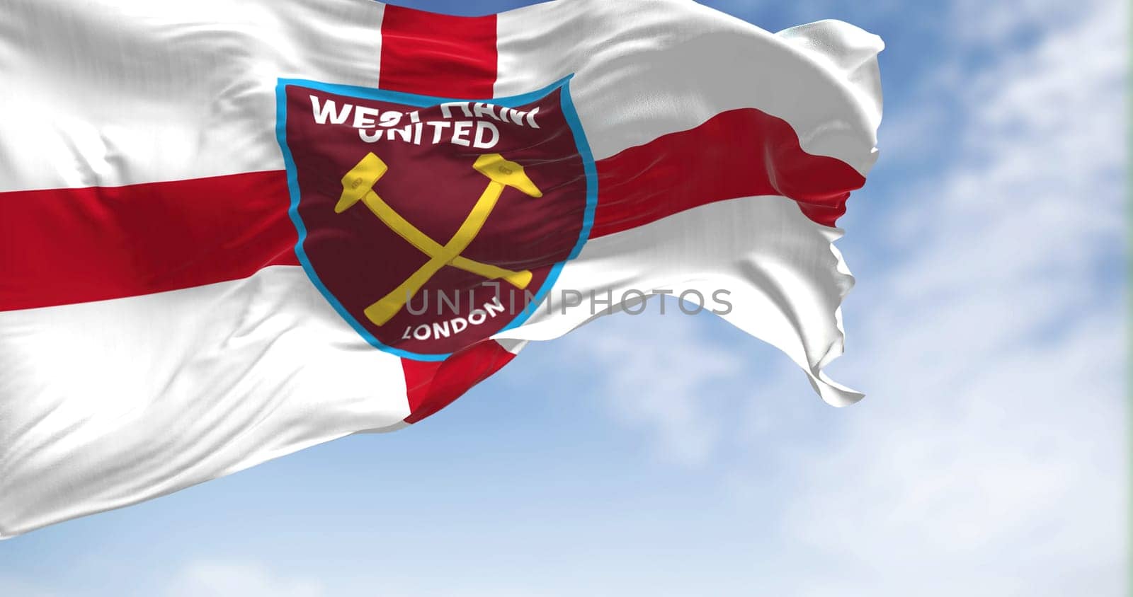 London, UK, Oct. 2022: The flag of West Ham United F.C. waving in the wind on a clear day. West Ham United F.C is an English football club based in London. Rippled fabric. Realistic 3d illustration