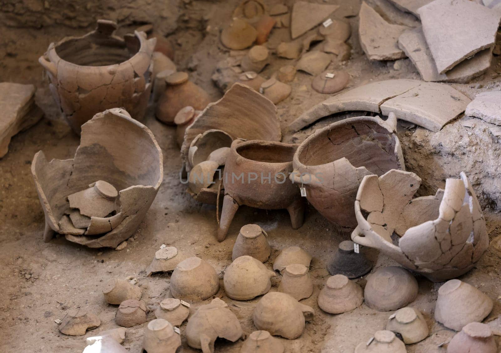 Santorini, Greece - July 01, 2021: Recovered ancient pottery in prehistoric town of Akrotiri, excavation site of a Minoan Bronze Age settlement on the Greek island of Santorini