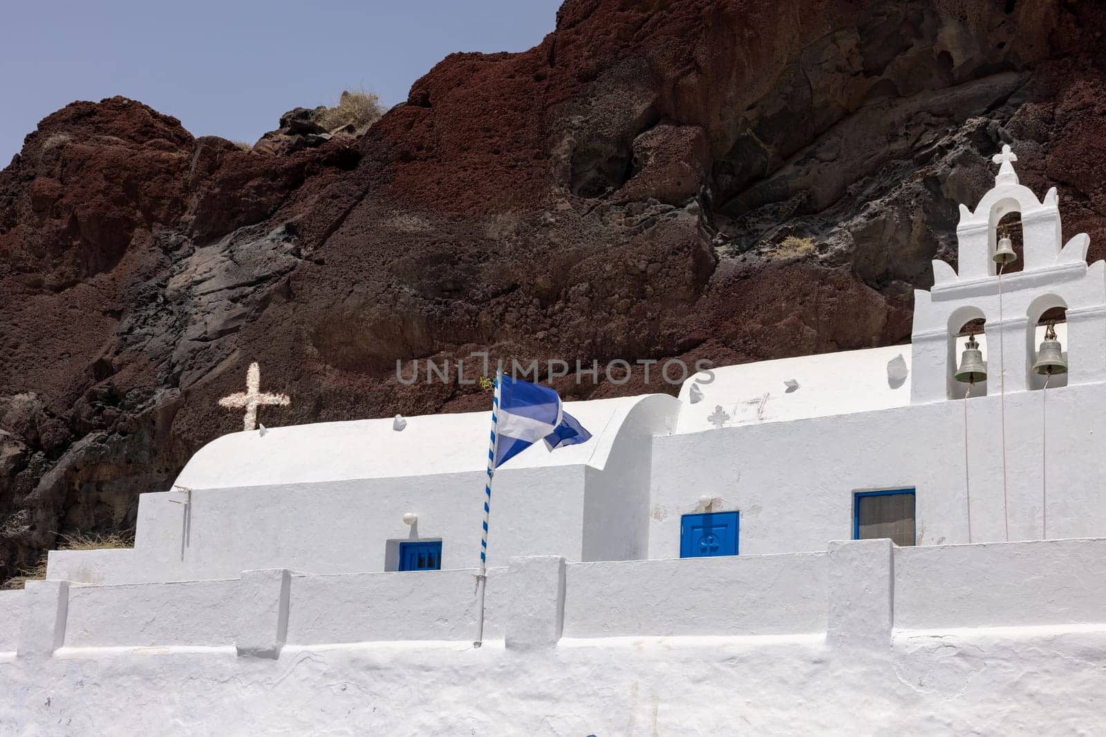Greek church built into the mountain located near the famous Red Beach of Akrotiri. Santorini Island, Greece