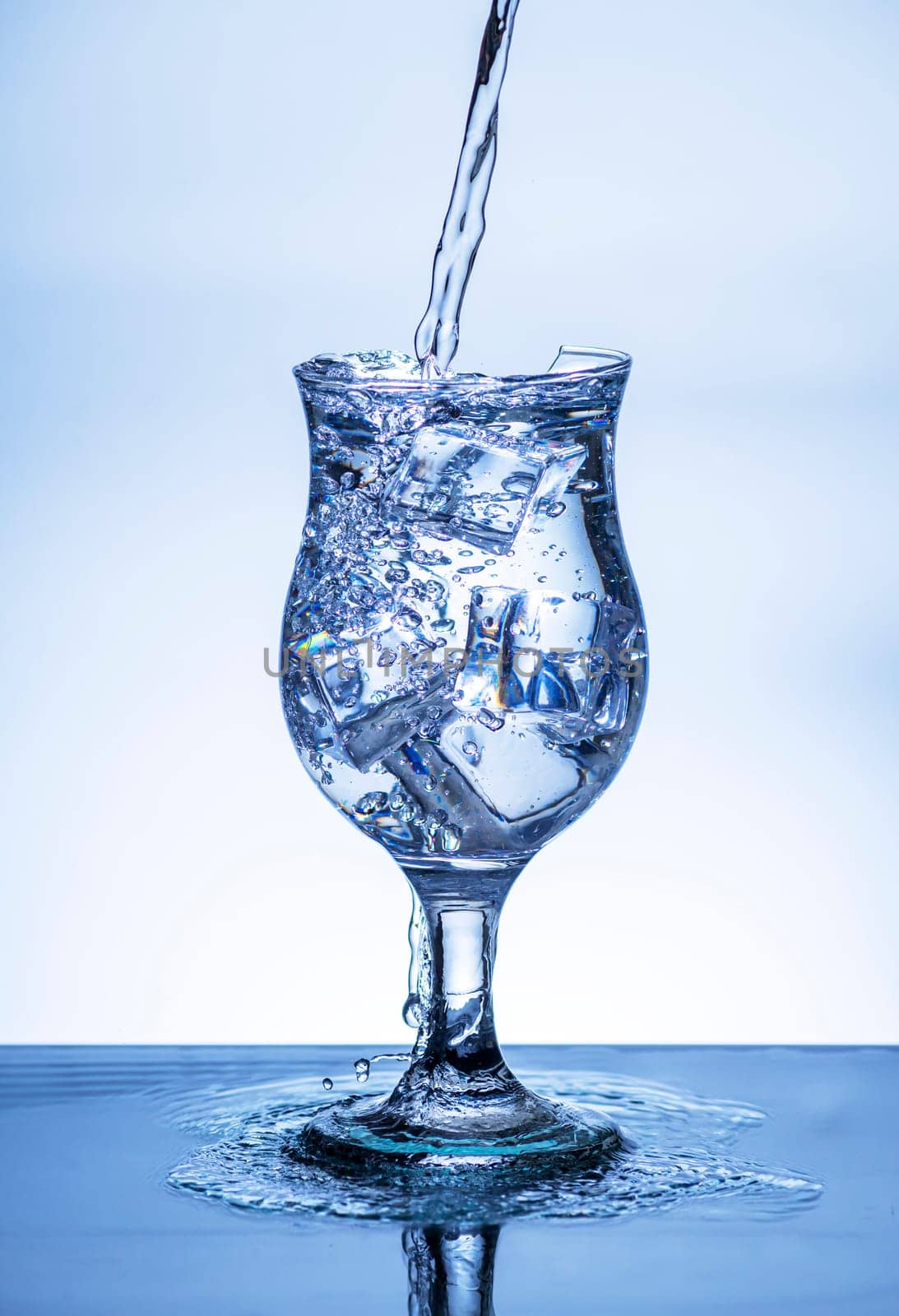 The image of pouring drinking water, into a broken glass, that makes one feel refreshed on blurred white background, Splashing water, Sparkling water, Danger or imminent danger concept