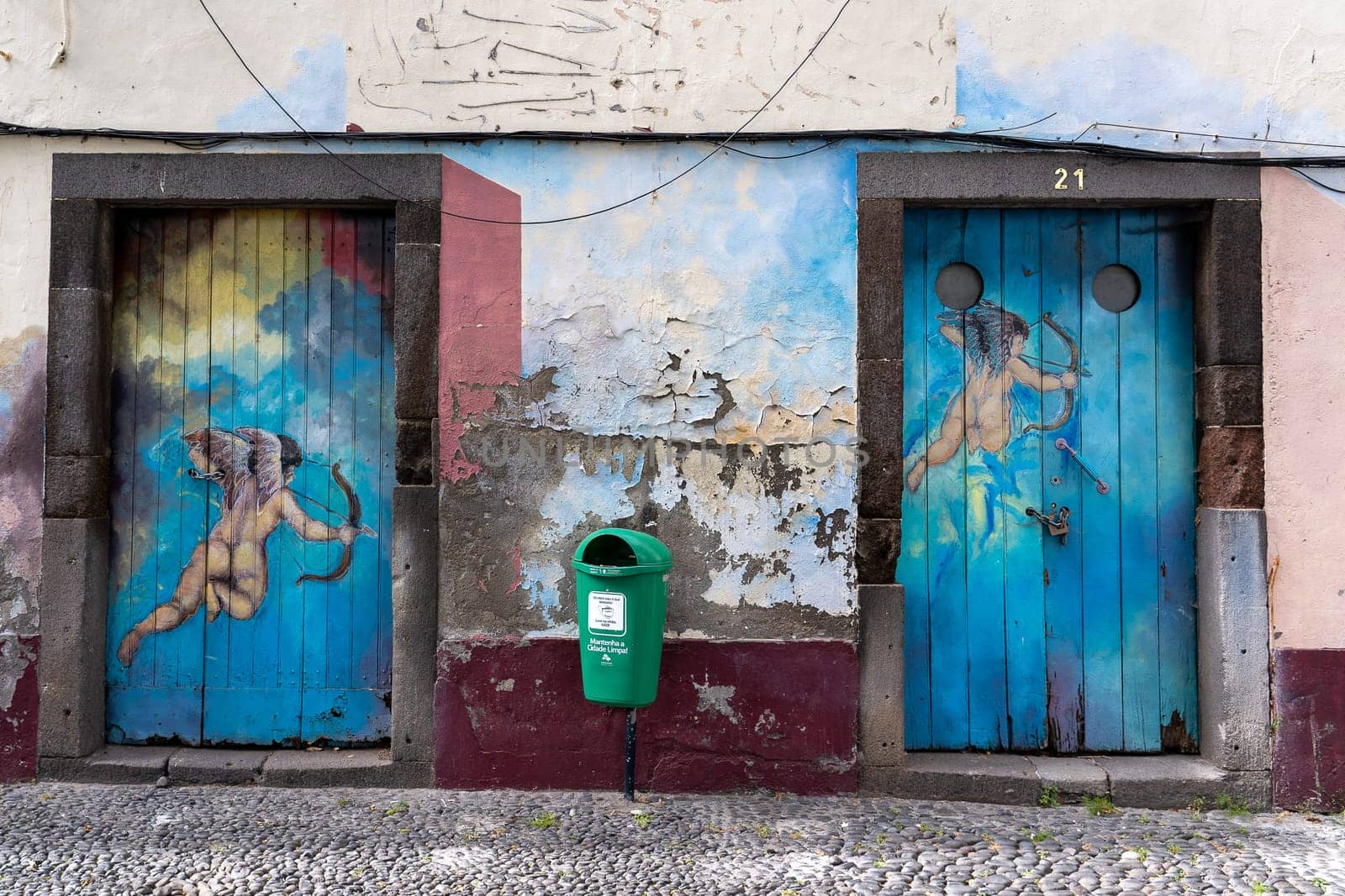 FUNCHAL, MADEIRA, PORTUGAL - JULY 12, 2021: Ruinous facades painted in the streets of the historic center of the city