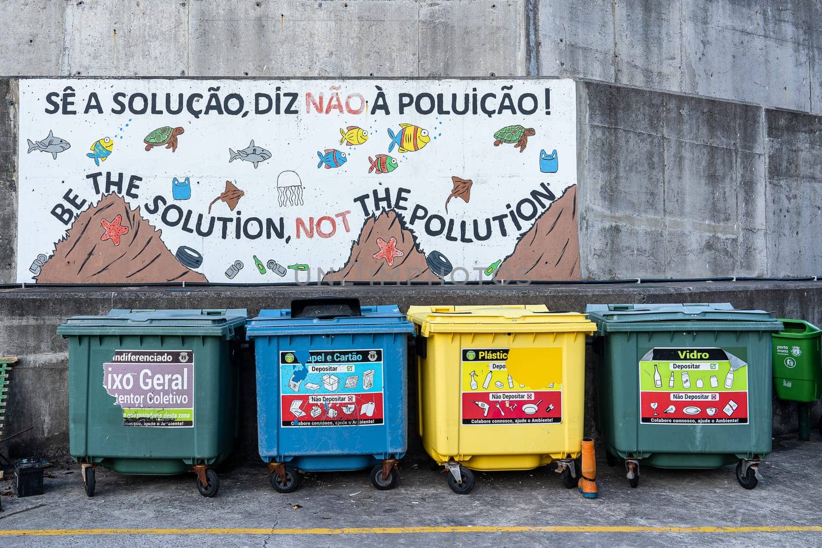Porto Moniz, Madeira/Portugal - July 21 2021. Large colorful garbage bins dedicated for separate collection of rubbish.