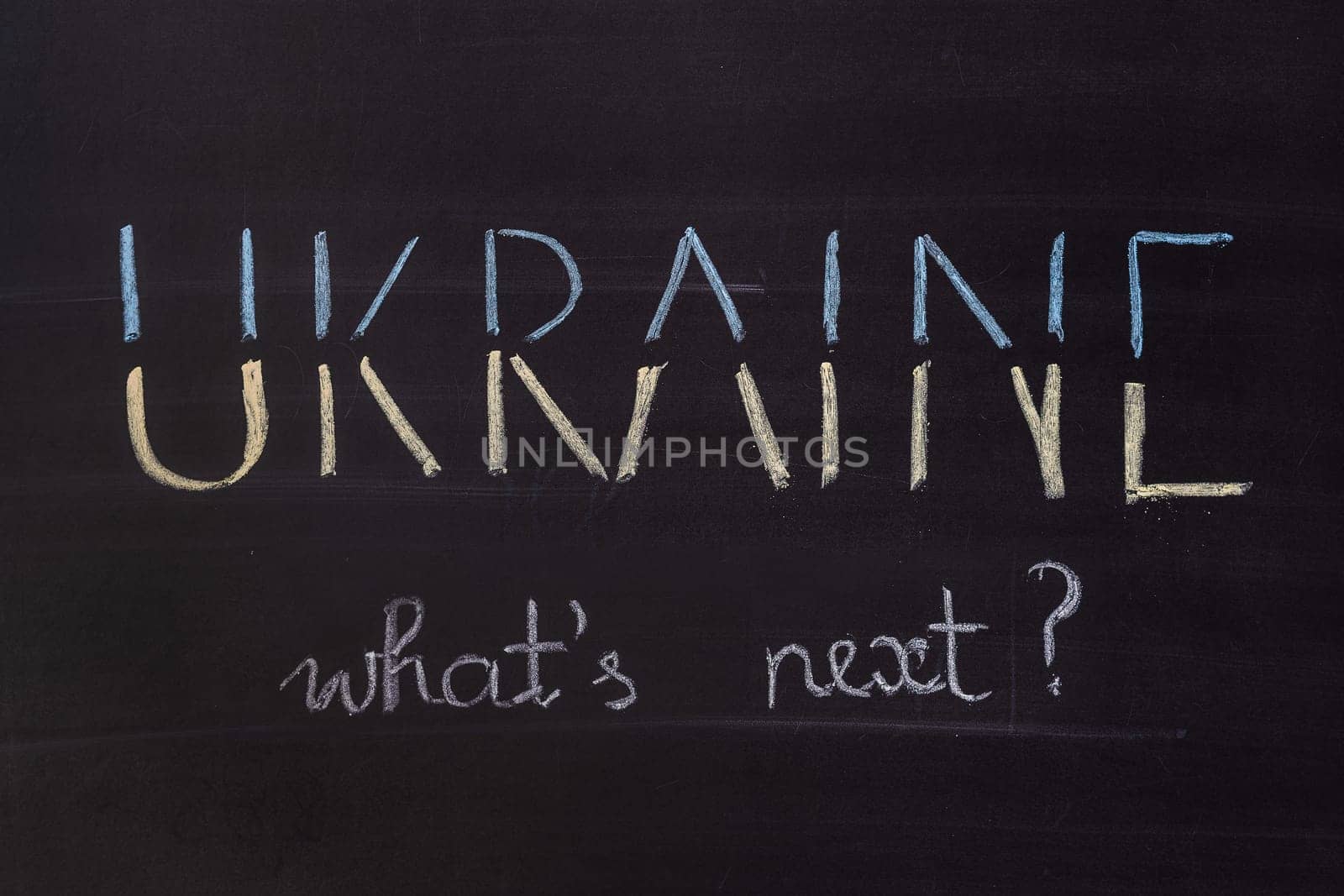 Word "Ukraine, What's next"" writed on blackboard with chalk"