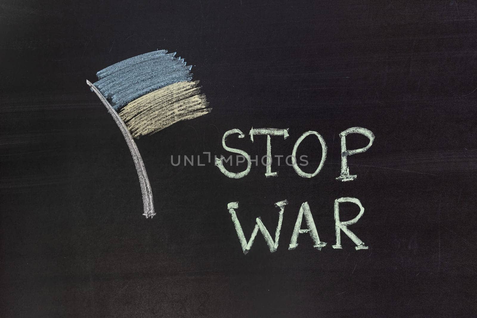 Word "Stop war"" writed on blackboard with chalk"