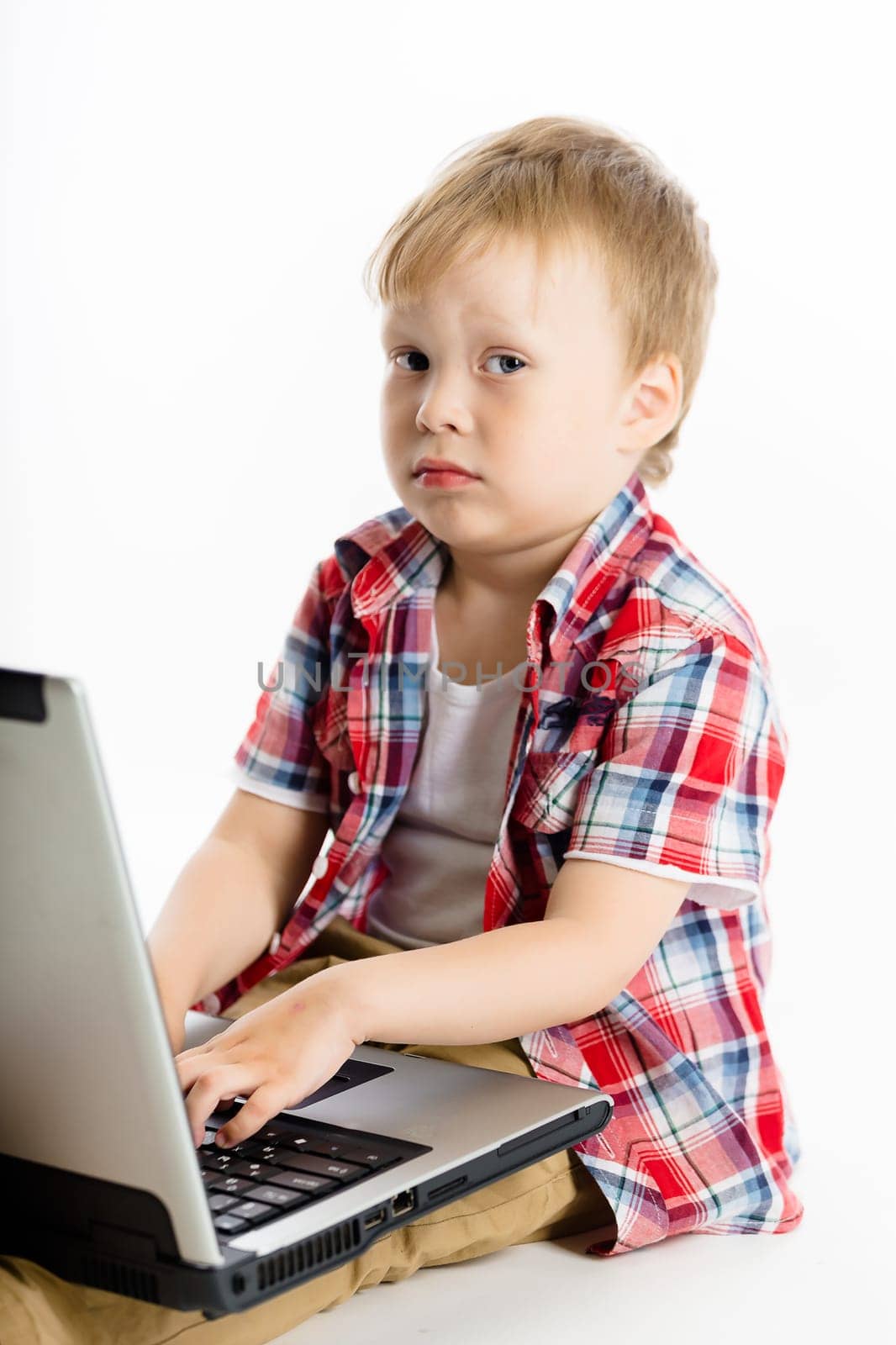 The little boy with a laptop. studio